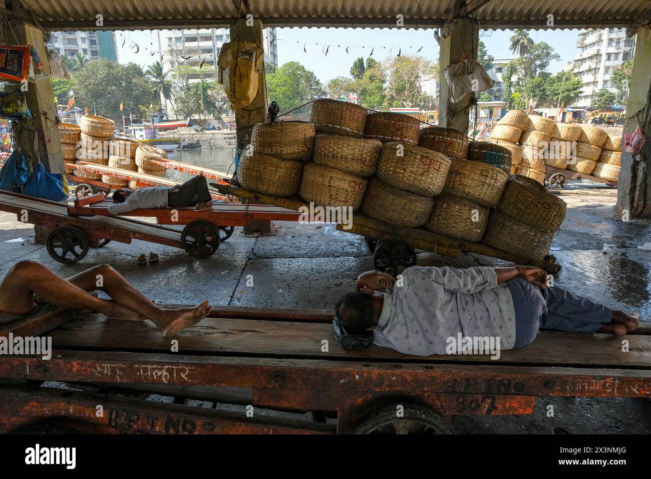 Mumbai, India - March 8, 2024: Fishermen resting at the Sassoon Dock in the Colaba district of Mumbai, India. Stock Photo