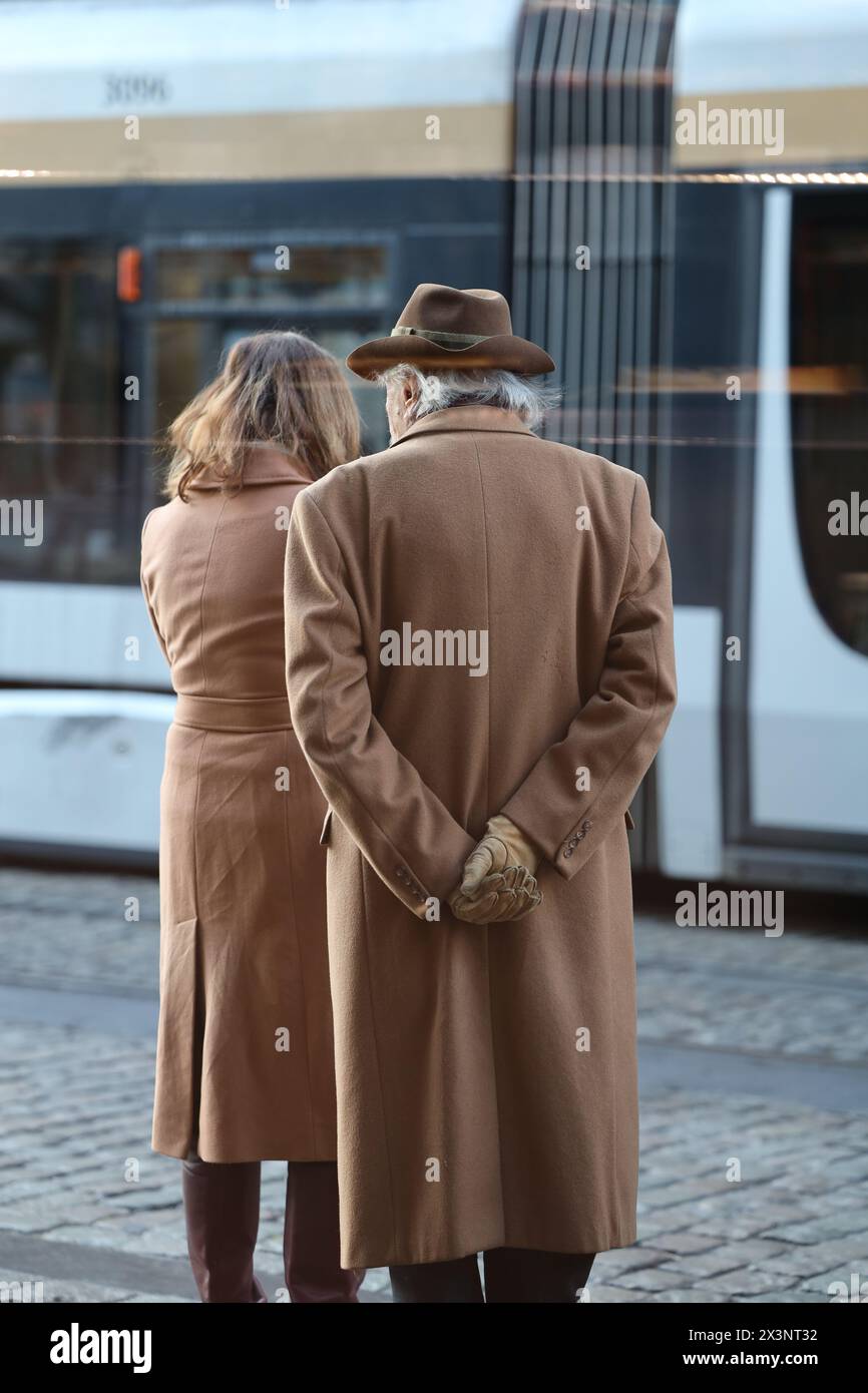 Old fashionable couple waiting for their tram in the streets of Brussels, Belgium. Streetstyle. Stock Photo