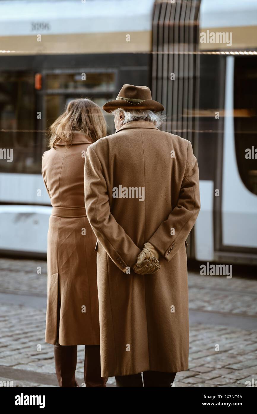 Old fashionable couple waiting for their tram in the streets of Brussels, Belgium. Streetstyle. Stock Photo