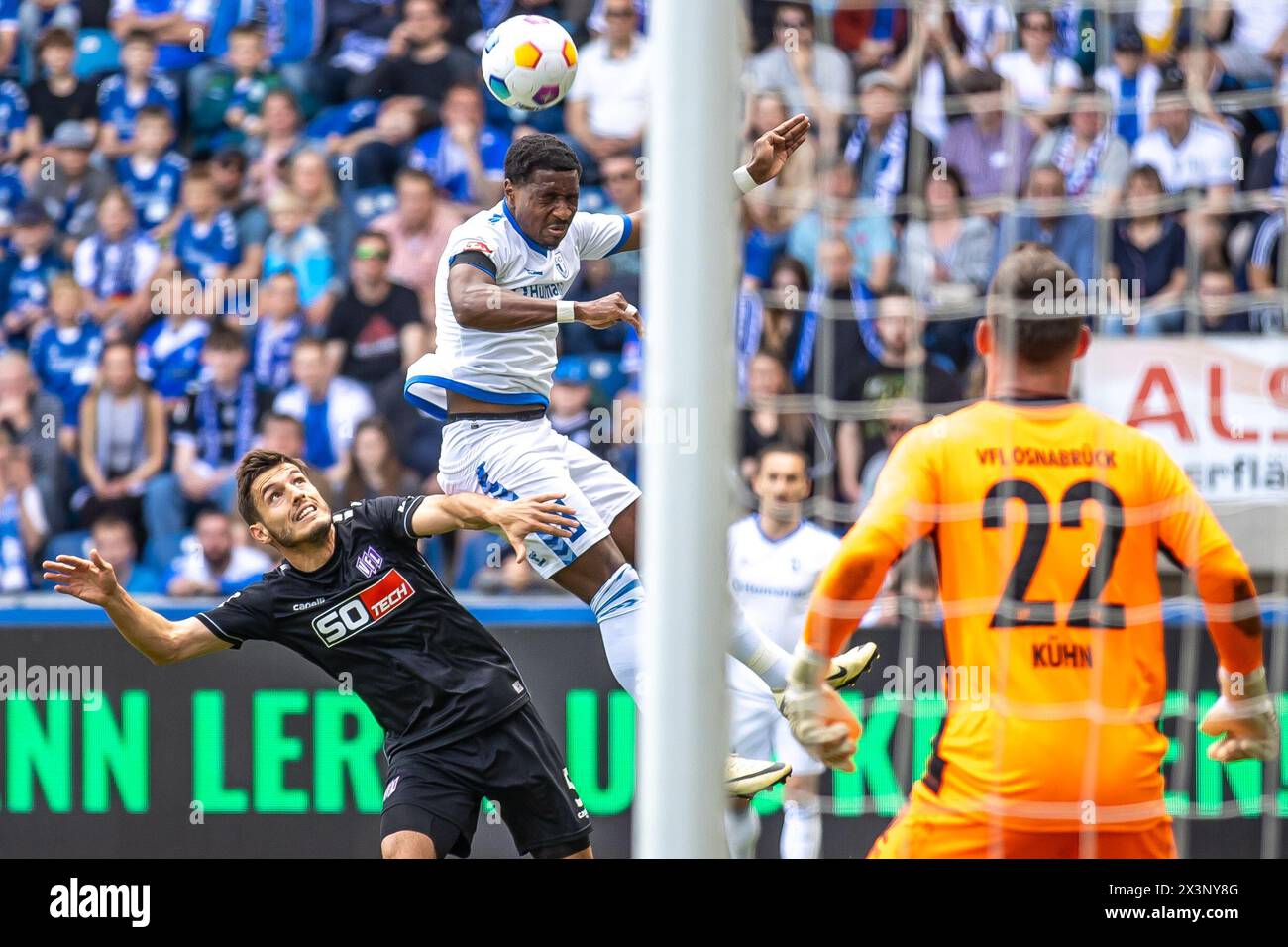 Magdeburg, Germany. 28th Apr, 2024. Soccer: Bundesliga 2, 1. FC Magdeburg - VfL Osnabrück, Matchday 31, MDCC-Arena. Bryan Teixeira (M) of 1. FC Magdeburg goes for a header against Osnabrück's Bashkim Ajdini. Credit: Andreas Gora/dpa - IMPORTANT NOTE: In accordance with the regulations of the DFL German Football League and the DFB German Football Association, it is prohibited to utilize or have utilized photographs taken in the stadium and/or of the match in the form of sequential images and/or video-like photo series./dpa/Alamy Live News Stock Photo
