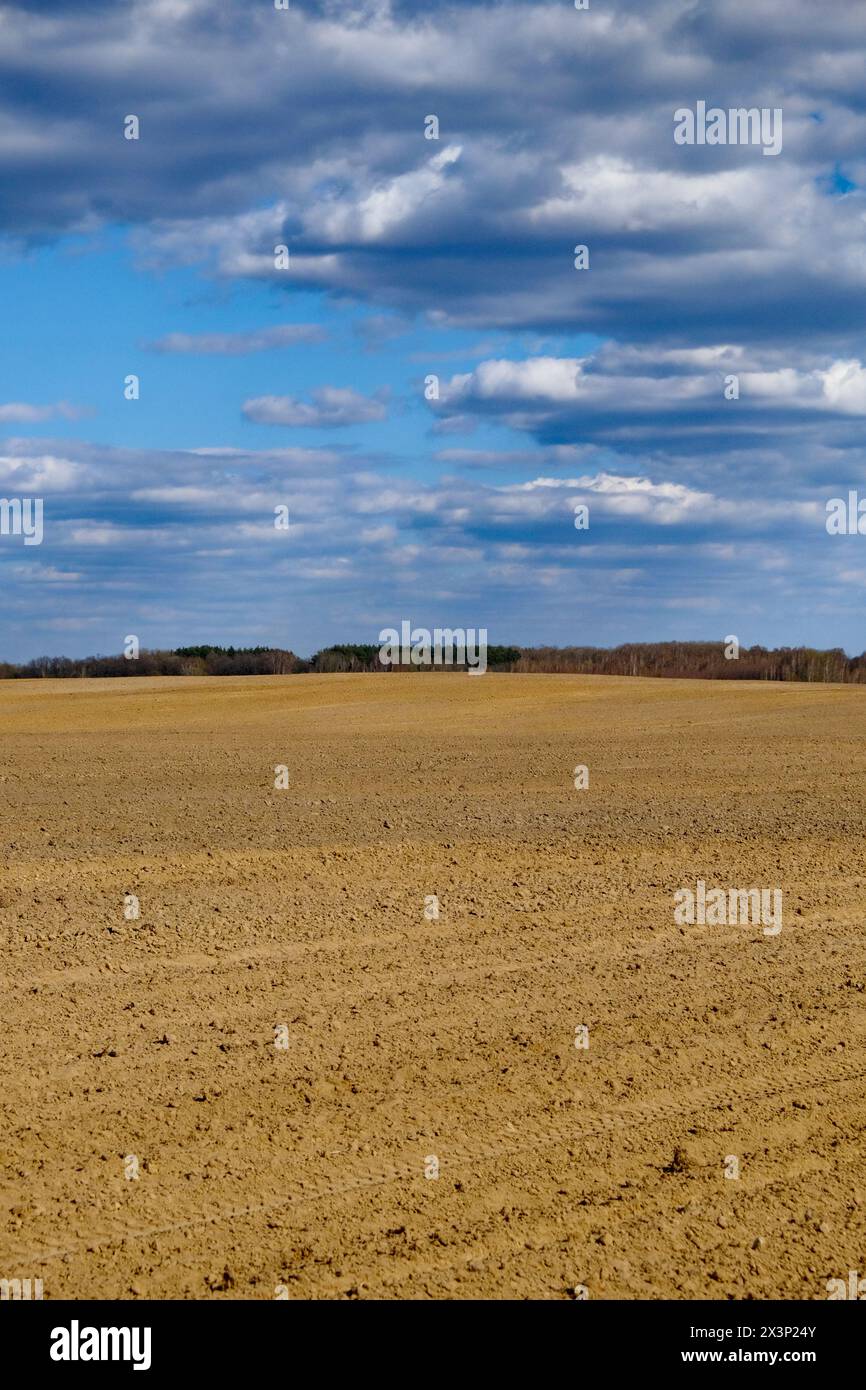 A clear day over freshly tilled agricultural land. Stock Photo