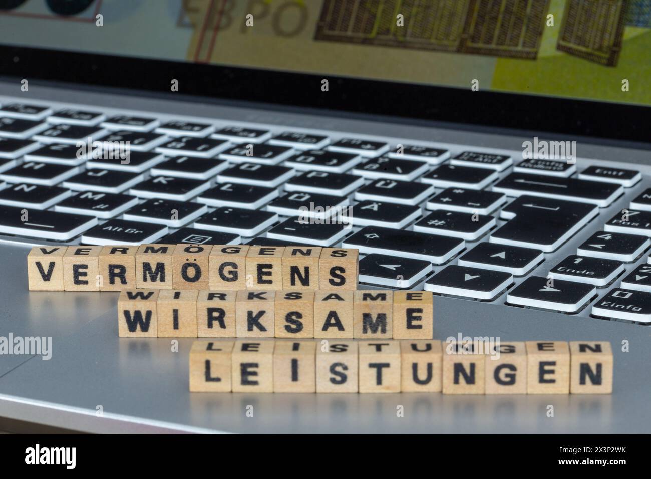 Symbol image of capital-forming benefits (Germany): The word VERMÖGENSWIRKSAME LEISTUNGEN (capital-forming benefits) is written on a laptop with lette Stock Photo