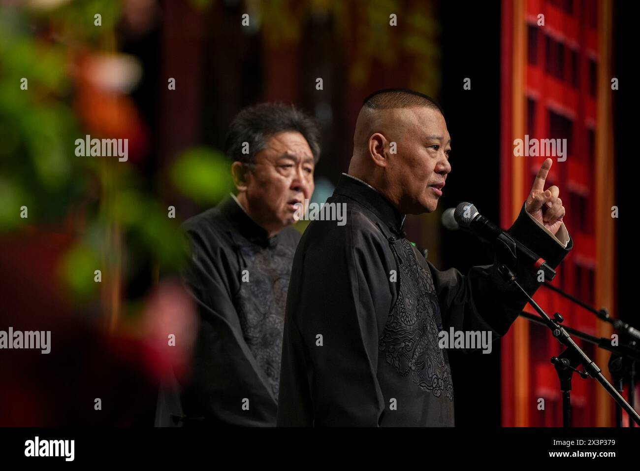 (240428) -- LONDON, April 28, 2024 (Xinhua) -- Guo Degang (R) and Yu Qian perform Xiangsheng, or crosstalk comedy in London, Britain, April 27, 2024. Thunderous laughter and applause almost blew off the roof of an auditorium in London's ExCeL Exhibition Centre on Saturday night, when a punchline by Guo Degang, a popular Chinese traditional crosstalk comedian, landed with an audience of thousands. Along with Guo and his partner Yu Qian, a handful of comedians from the De Yun She Performance Group performed Xiangsheng, or crosstalk comedy, with both jokes about life anecdotes and traditional Stock Photo