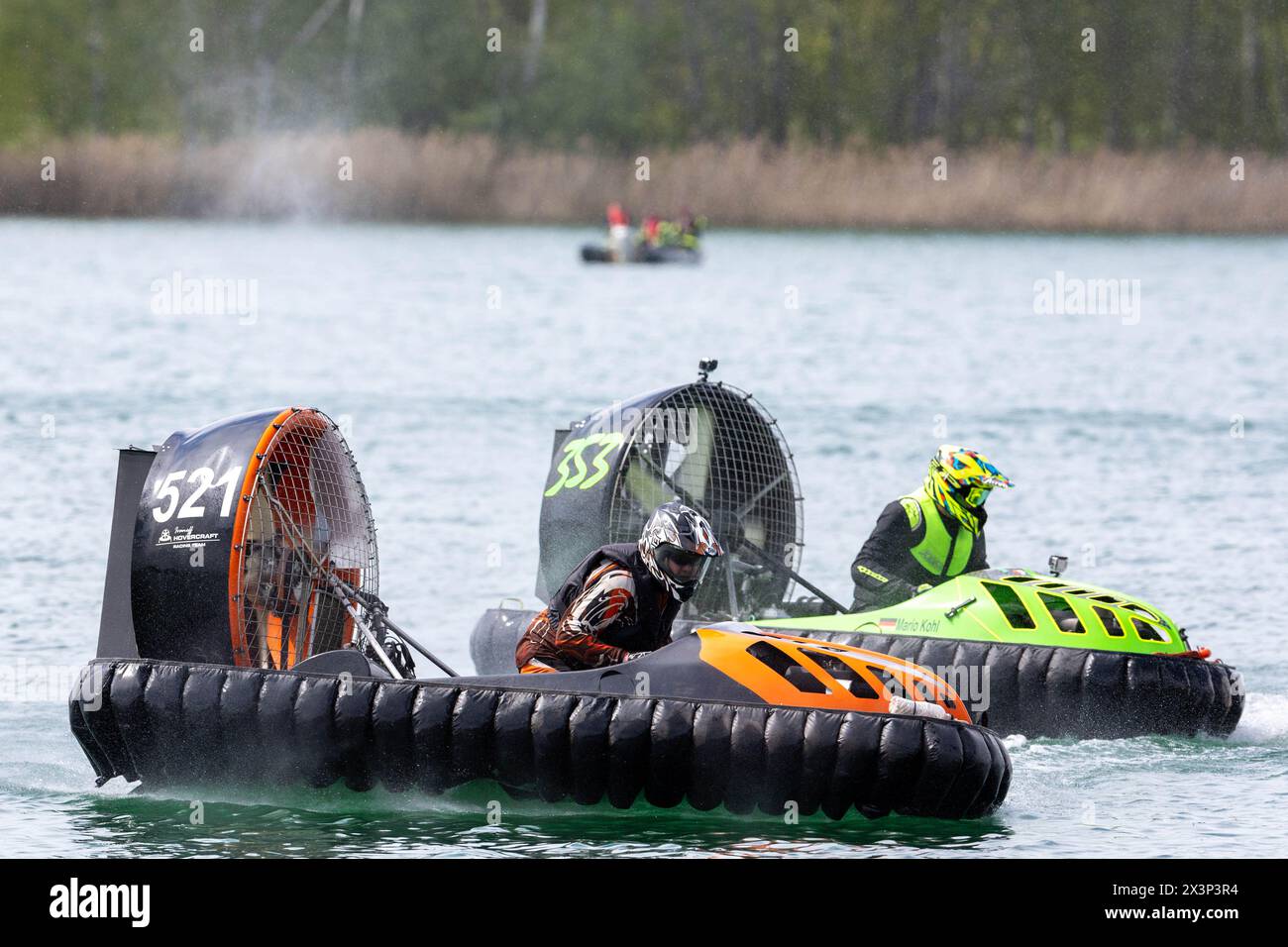 28 April 2024, Saxony, Weißwasser: Mario Kohl from Germany (right) puts pressure on Magnus Ivanoff from Sweden (left). At the European Hovercraft Championships on Halbendorfer See near Weißwasser, the riders travel across the water at around 140 km/h. Photo: Daniel Schäfer/dpa Stock Photo