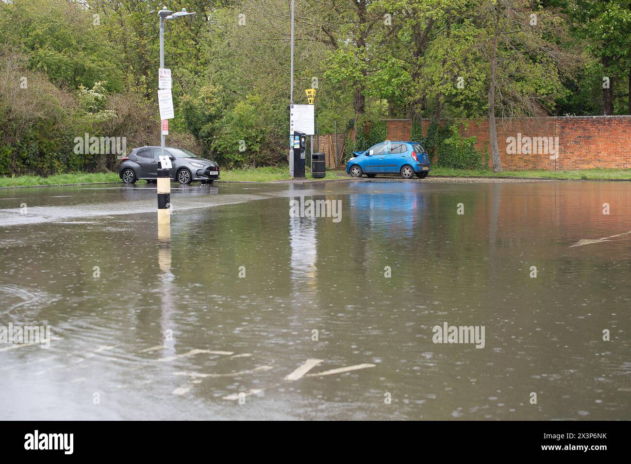 Chalfont St Giles, Buckinghamshire, UK. 28th April, 2024. A flooded car park. Parts of the village of Chalfont St Giles in Buckinghamshire was flooded again today after heavy overnight rain. There are ongoing issues with groundwater flooding across the Chalfonts. Credit: Maureen McLean/Alamy Live News Stock Photo