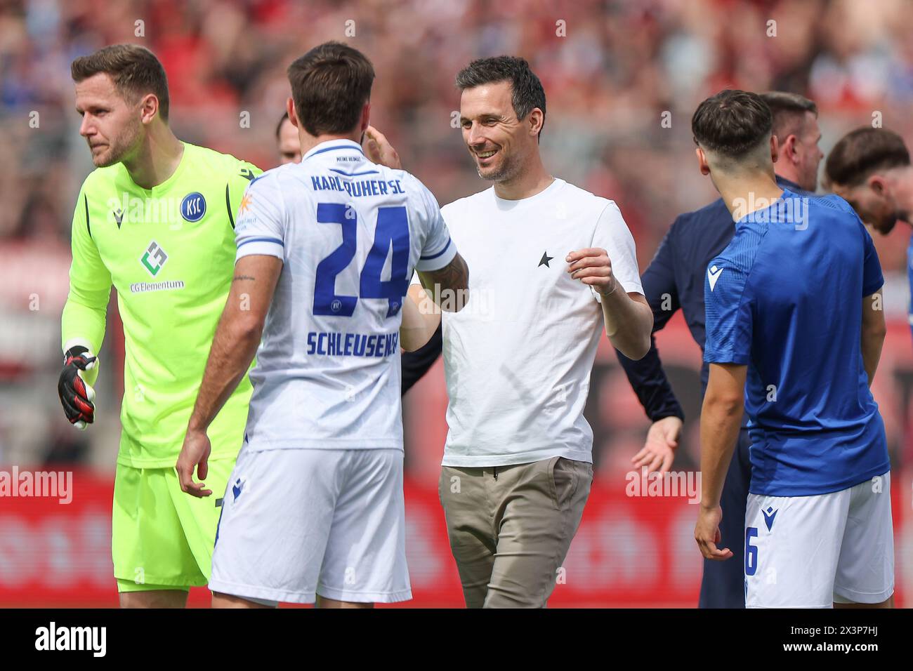 Nuremberg, Germany. 28th Apr, 2024. Soccer: Bundesliga 2, 1. FC Nürnberg - Karlsruher SC, matchday 31, Max-Morlock-Stadion. Karlsruhe coach Christian Eichner (M) celebrates the 1:0 victory with Fabian Schleusener (2nd from left). Credit: Daniel Löb/dpa - IMPORTANT NOTE: In accordance with the regulations of the DFL German Football League and the DFB German Football Association, it is prohibited to utilize or have utilized photographs taken in the stadium and/or of the match in the form of sequential images and/or video-like photo series./dpa/Alamy Live News Stock Photo