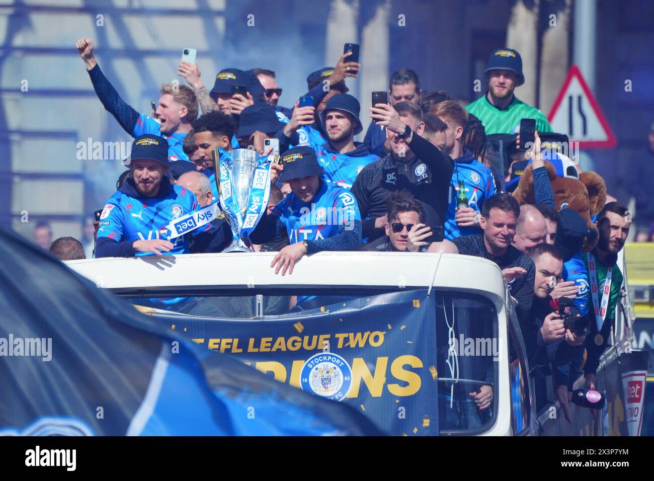 Stockport County Players celebrate during an opentop bus parade in