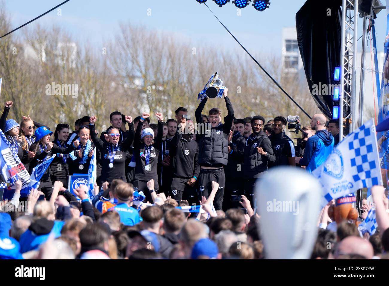 Portsmouth players with the trophy during a celebration event at Southsea Common in Portsmouth to celebrate winning the Sky Bet League One title. Picture date: Sunday April 28, 2024. Stock Photo