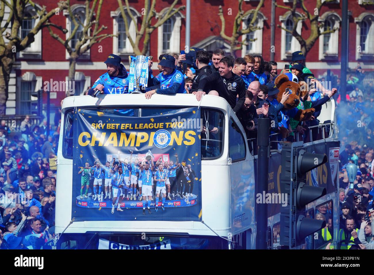 Stockport County Players celebrate during an opentop bus parade in