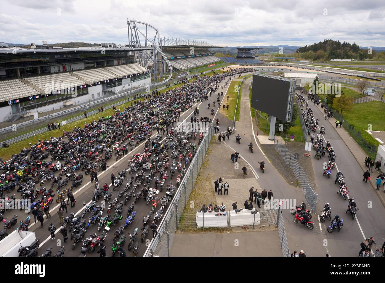 28 April 2024, Rhineland-Palatinate, Nürburg: Thousands of motorcyclists meet at the Nürburgring to kick off the motorcycle season under the title 'Anlassen'. The schedule includes an ecumenical church service and a parade around the Nordschleife of the Eifel racetrack. Photo: Thomas Frey/dpa Stock Photo