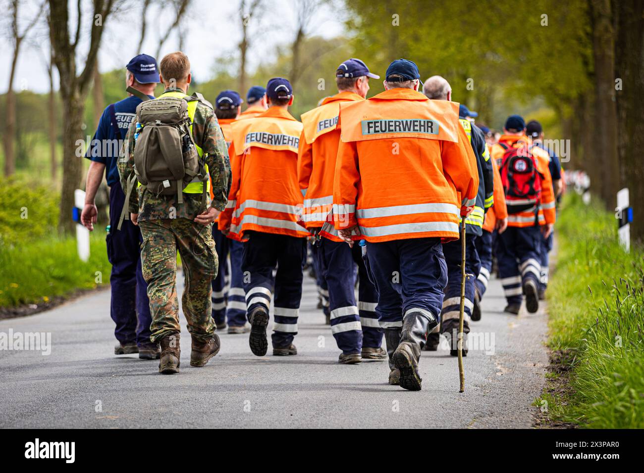 28 April 2024, Lower Saxony, Gräpel: Firefighters walk along a road in the district of Stade. Six-year-old Arian from Elm is still missing. The search for him continues. Photo: Moritz Frankenberg/dpa Stock Photo