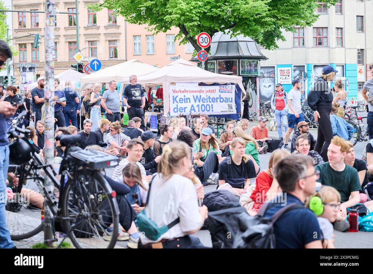 Berlin, Germany. 28th Apr, 2024. 'No further construction of the A100!' reads a banner at a protest against Tesla. Members of various alliances such as 'Tesla den Hahn abdrehen', 'A100 stoppen!' and 'Görlitz zaunfrei!' celebrate a street party in Kreuzberg to demonstrate against Tesla and car policy. Credit: Annette Riedl/dpa/Alamy Live News Stock Photo