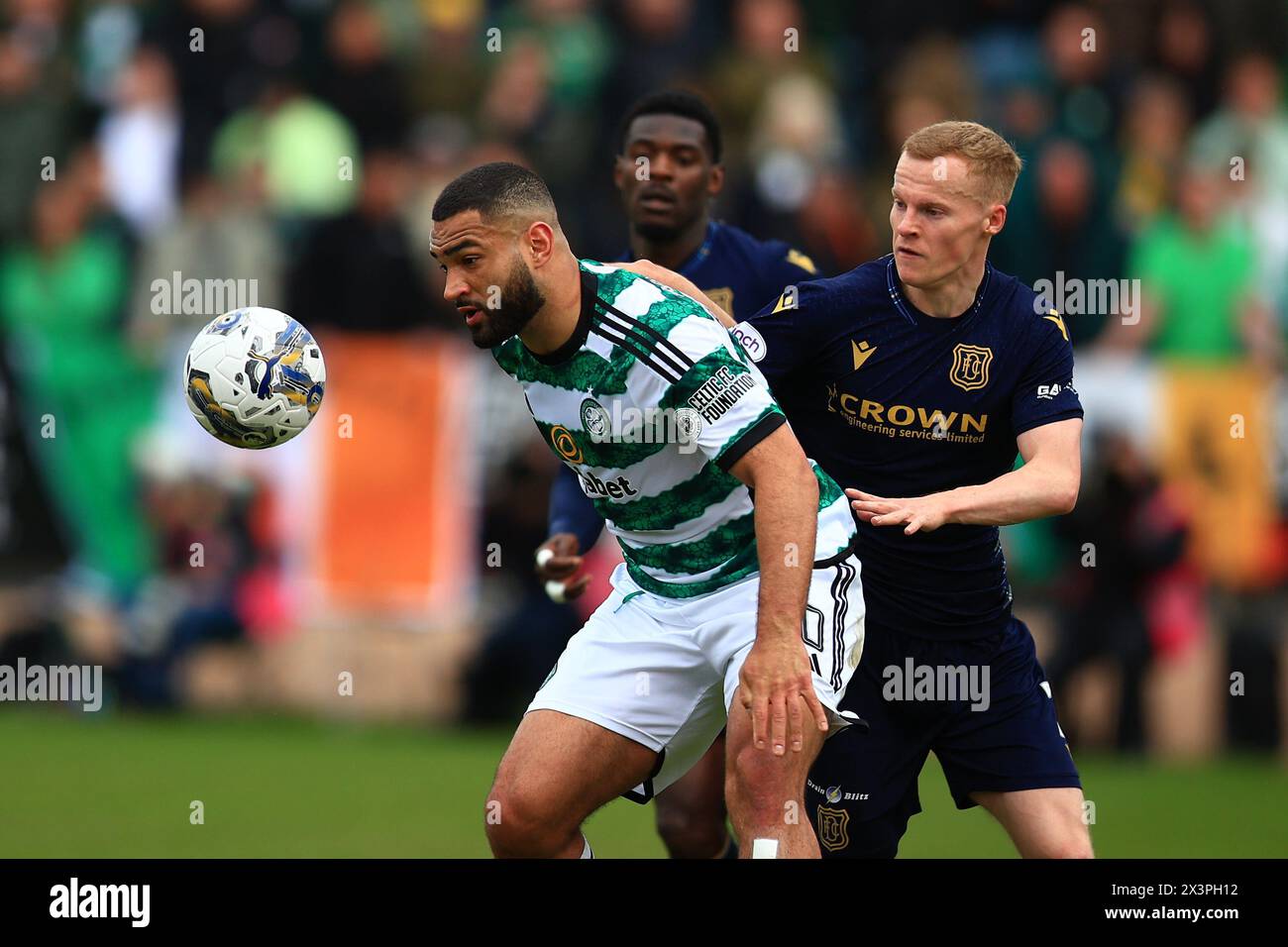 Dens Park, Dundee, UK. 28th Apr, 2024. Scottish Premiership Football, Dundee versus Celtic; Cameron Carter-Vickers of Celtic challenges for the ball with Scott Tiffoney of Dundee Credit: Action Plus Sports/Alamy Live News Stock Photo