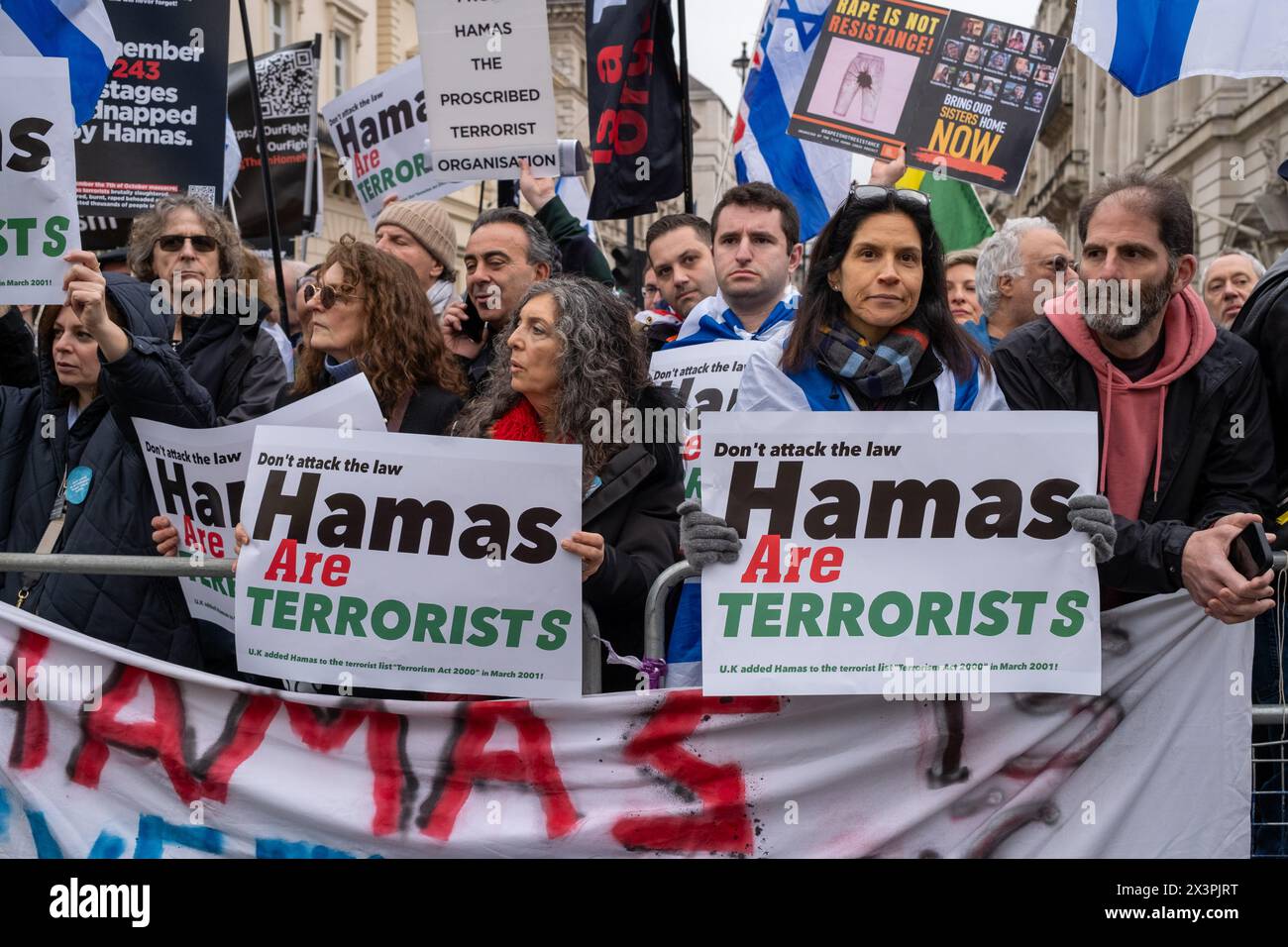 Counter protesters hold Hamas are terrorists placards during the demonstration. After several months of pro Palestinian marches held in Central London anti Hamas and pro Israeli demonstrations have started to grow in size and support. Members of the Jewish and British Israeli community have held counter protests along the route of the large Palestinian marches held every two weeks in Central London. Rows of Police and barriers separate the two groups. The Palestinian groups have stated they will continue to march until there is a permanent cease fire in Gaza.With growing support the counter pr Stock Photo