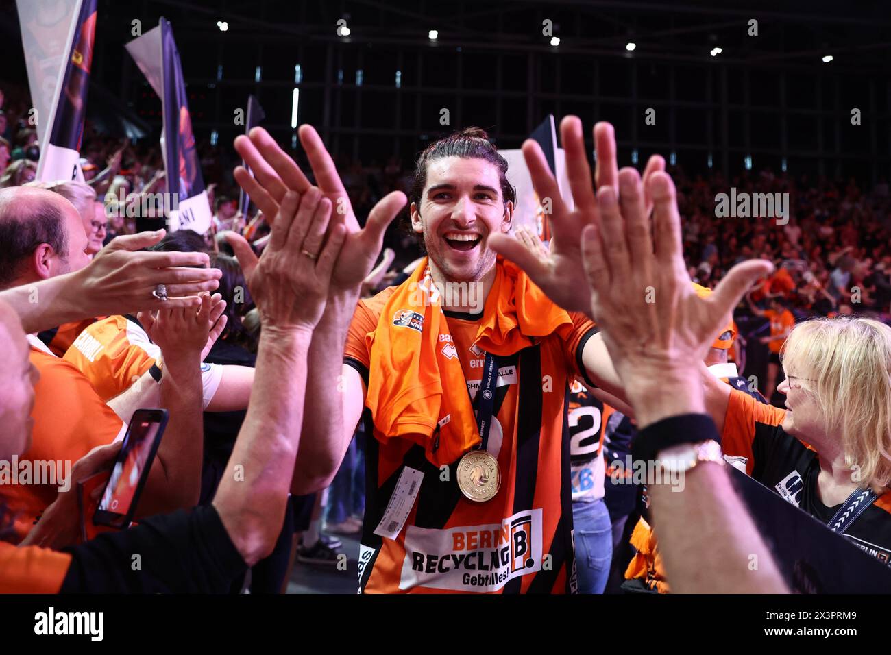 Berlin, Germany. 28th Apr, 2024. Volleyball, Men: Bundesliga, Berlin Volleys - VfB Friedrichshafen Championship round, Final, Matchday 5, Max-Schmeling-Halle. Berlin's Timothée Carle (M) high-fives with fans after the win. Credit: Christoph Soeder/dpa/Alamy Live News Stock Photo