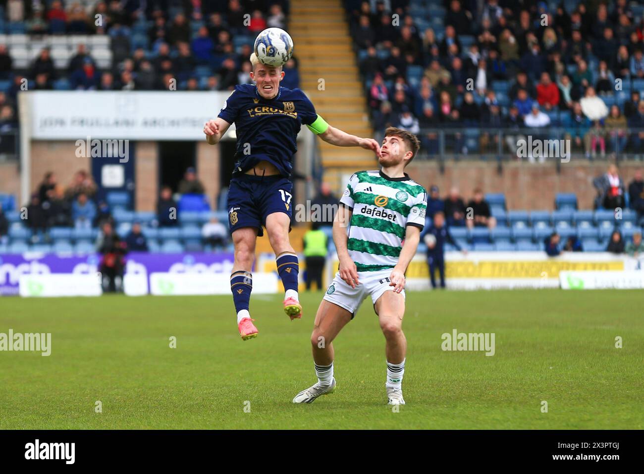 Dens Park, Dundee, UK. 28th Apr, 2024. Scottish Premiership Football, Dundee versus Celtic; Luke McCowan of Dundee heads the ball as James Forrest of Celtic watches Credit: Action Plus Sports/Alamy Live News Stock Photo