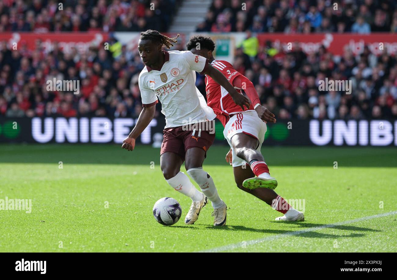 The City Ground, Nottingham, UK. 28th Apr, 2024. Premier League Football, Nottingham Forest versus Manchester City; Jeremy Doku of Manchester City runs with the ball under pressure from Ola Aina of Nottingham Forest Credit: Action Plus Sports/Alamy Live News Stock Photo