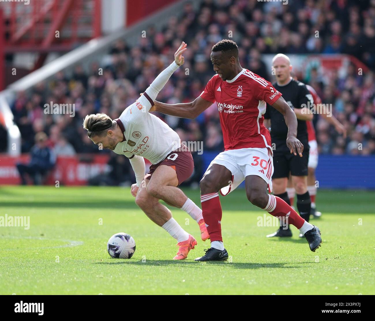 The City Ground, Nottingham, UK. 28th Apr, 2024. Premier League Football, Nottingham Forest versus Manchester City; Jack Grealish of Manchester City under pressure from Willy Boly of Nottingham Forest Credit: Action Plus Sports/Alamy Live News Stock Photo