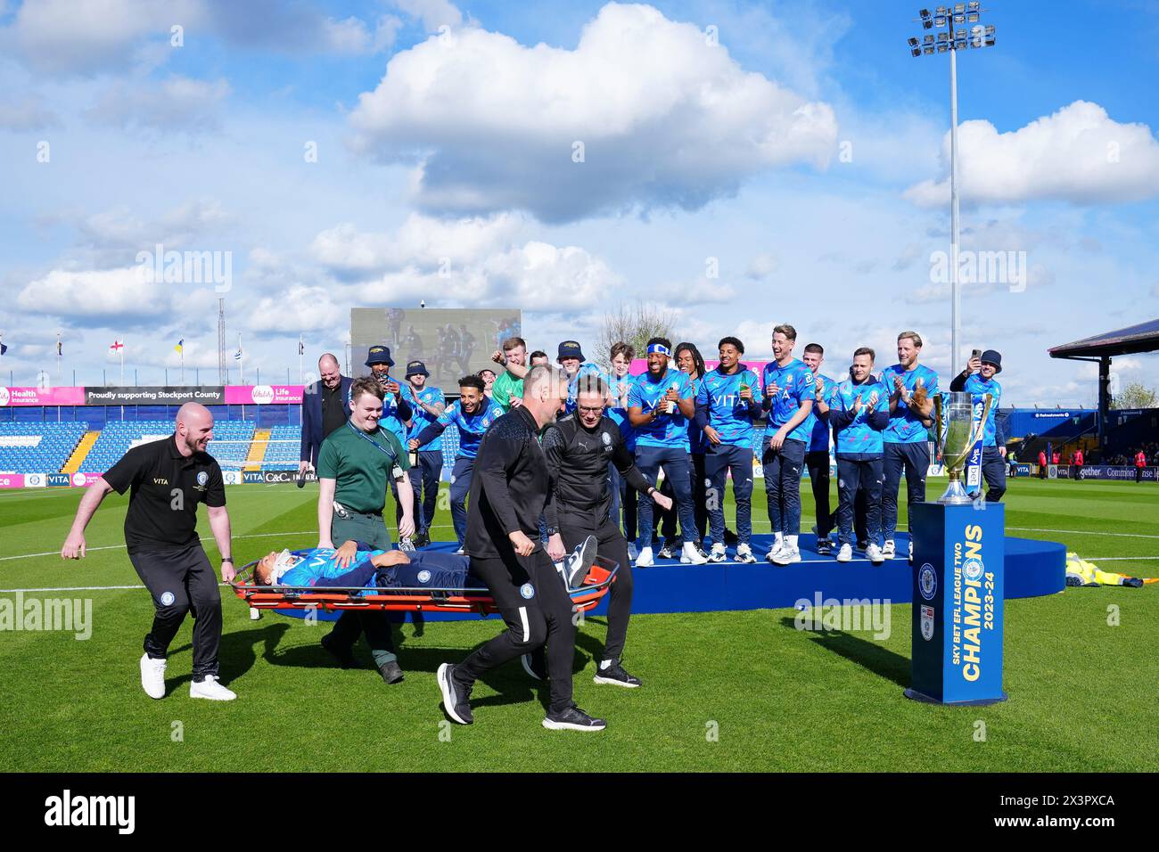 Stockport County's Kyle Knoyle arrives on a stretcher during a presentation at Edgeley Park, Stockport to celebrate winning the Sky Bet League Two title. Picture date: Sunday April 28, 2024. Stock Photo