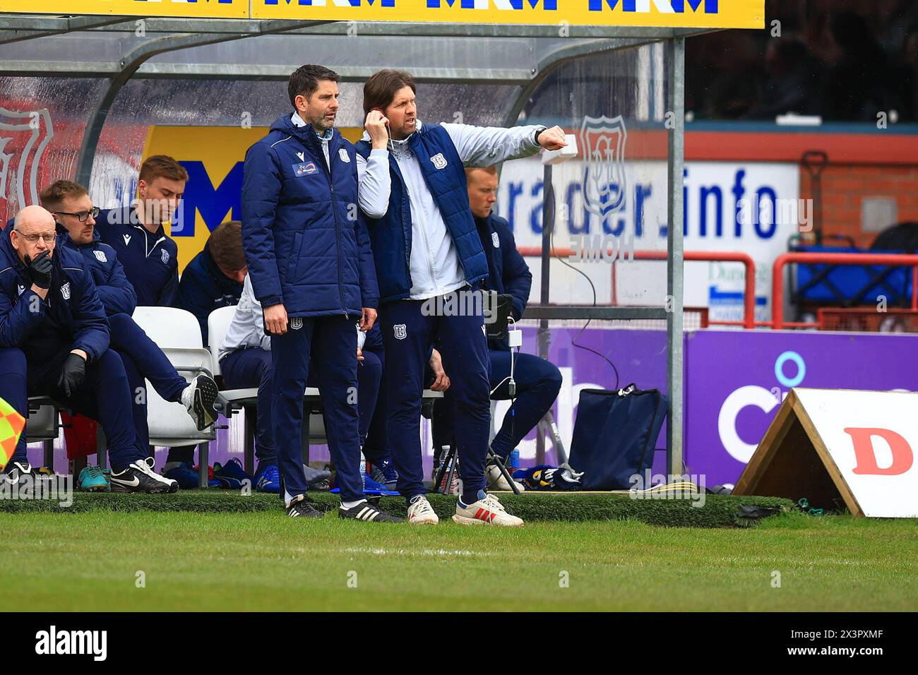 Dens Park, Dundee, UK. 28th Apr, 2024. Scottish Premiership Football, Dundee versus Celtic; Dundee assistant manager Stuart Taylor gets advice from coach Scott Paterson Credit: Action Plus Sports/Alamy Live News Stock Photo