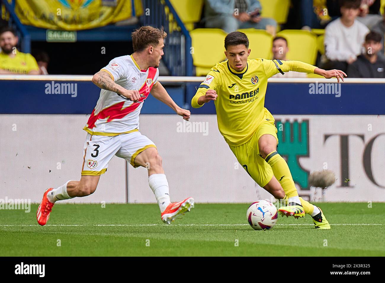 Villarreal, Spain. 28th Apr, 2024. VILLARREAL, SPAIN - APRIL 28: Ilias Akhomach Right Winger of Villarreal CF competes for the ball with Pep Chavarria Left-Back of Rayo Vallecano during the LaLiga EA Spots match between Villarreal CF and Rayo Vallecano at Estadio de la Ceramica, on April 28, 2024 in Villarreal, Spain. (Photo By Jose Torres/Photo Players Images) Credit: Magara Press SL/Alamy Live News Stock Photo