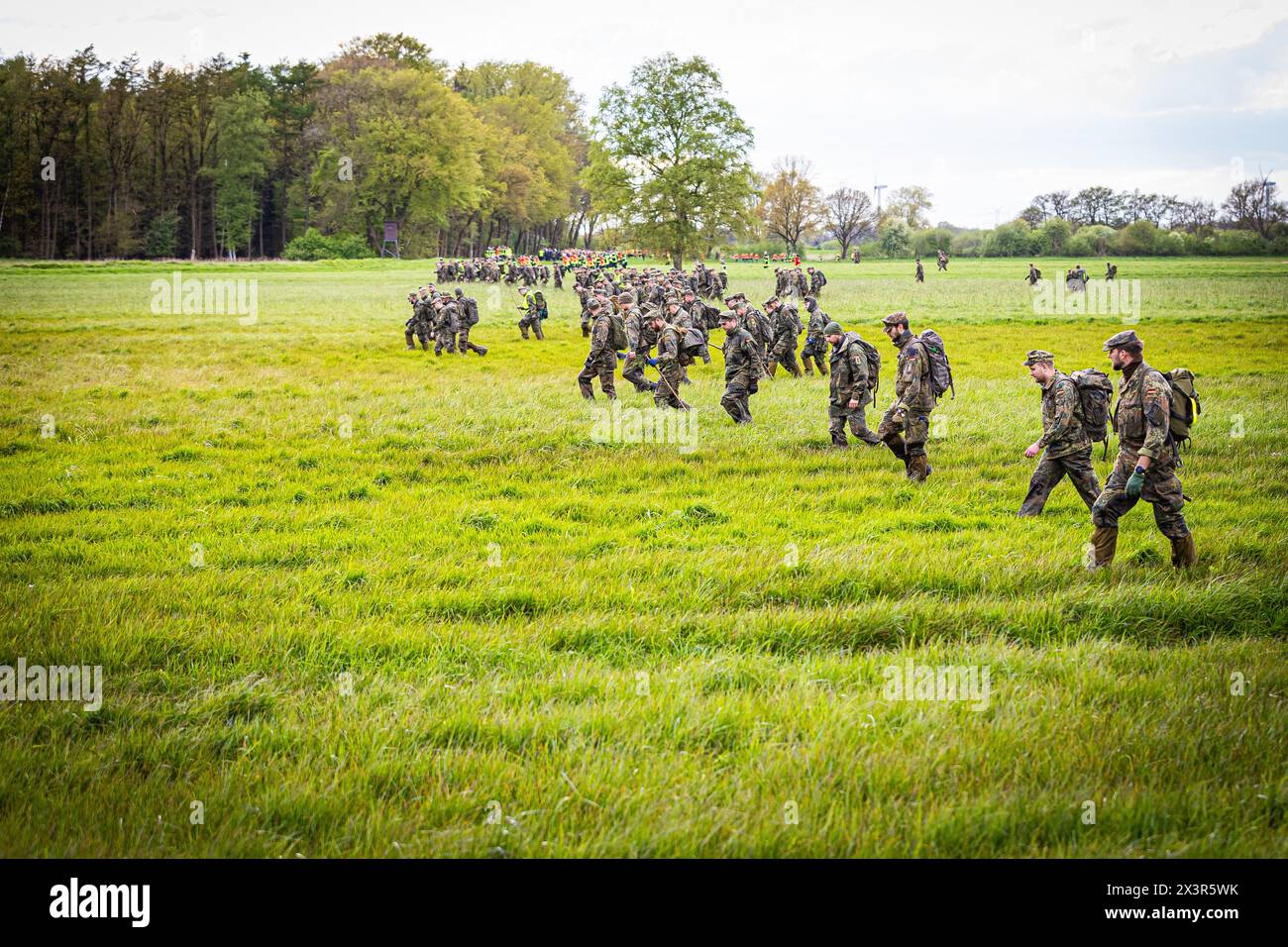 28 April 2024, Lower Saxony, Gräpel: Bundeswehr soldiers search a field ...