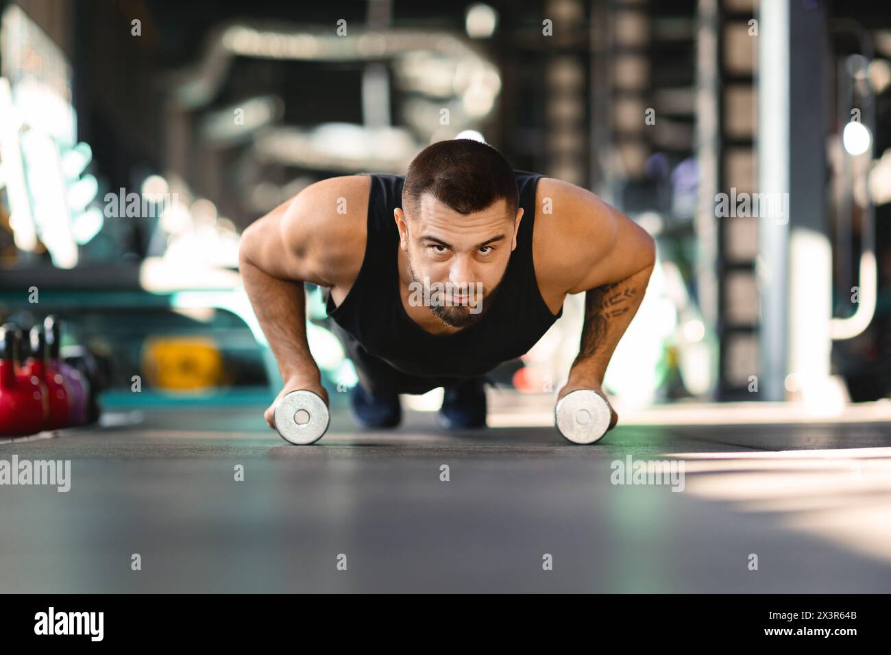 Man Doing Push Ups With Two Dumbbells Stock Photo