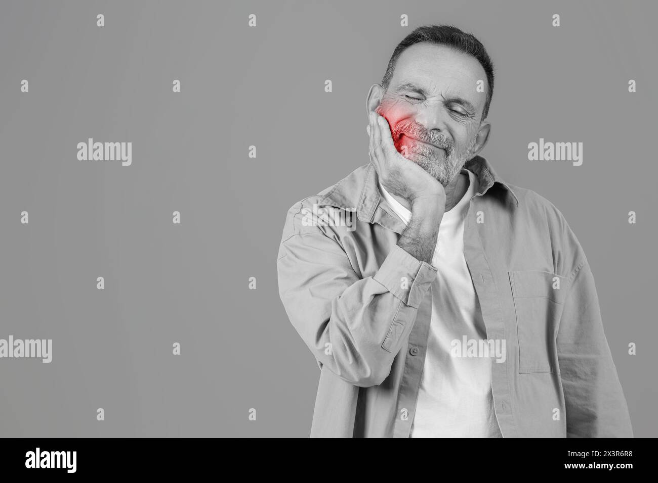 Man Holding Hand to Face, Experiencing Toothache Stock Photo