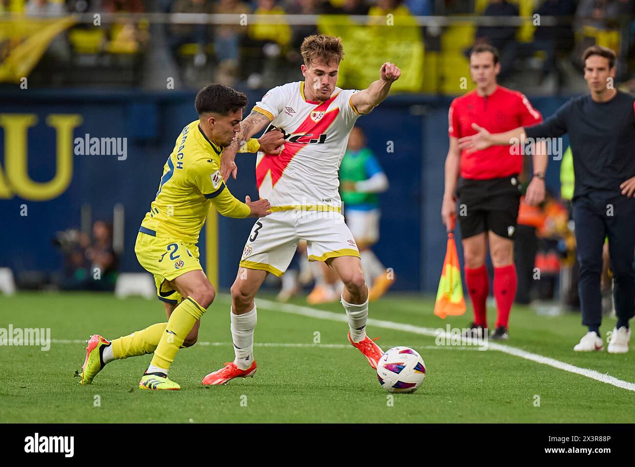 Villarreal, Spain. 28th Apr, 2024. VILLARREAL, SPAIN - APRIL 28: Ilias Akhomach Right Winger of Villarreal CF competes for the ball with Pep Chavarria Left-Back of Rayo Vallecano during the LaLiga EA Spots match between Villarreal CF and Rayo Vallecano at Estadio de la Ceramica, on April 28, 2024 in Villarreal, Spain. (Photo By Jose Torres/Photo Players Images) Credit: Magara Press SL/Alamy Live News Stock Photo