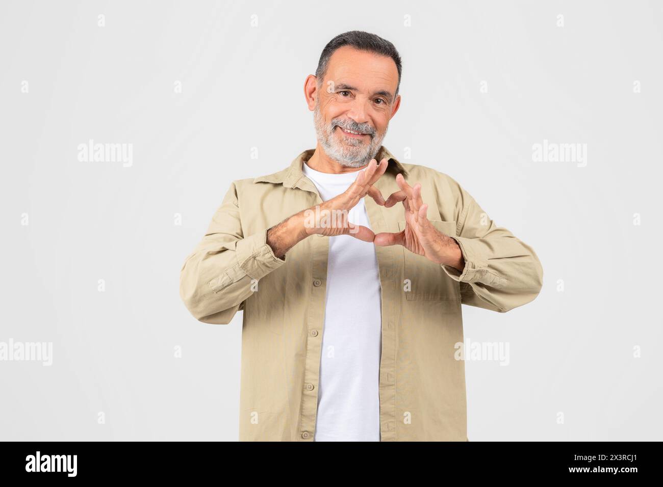 Man Making Heart Shape With Hands On White Stock Photo