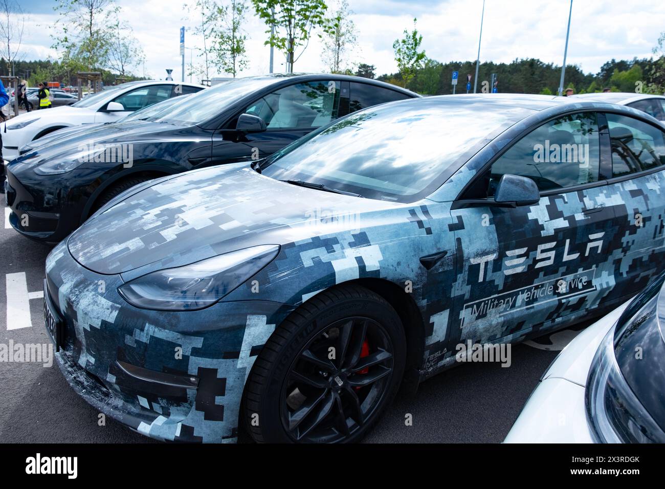 pixelated Tesla electric car refueling on street parking lot ...