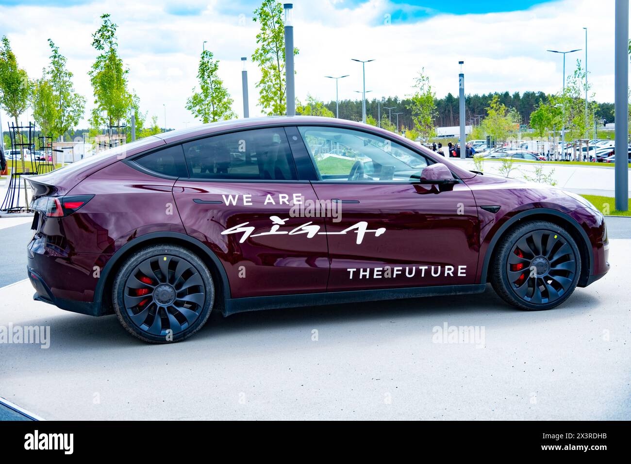cherry red Tesla model y electric car front Gigafactory Berlin