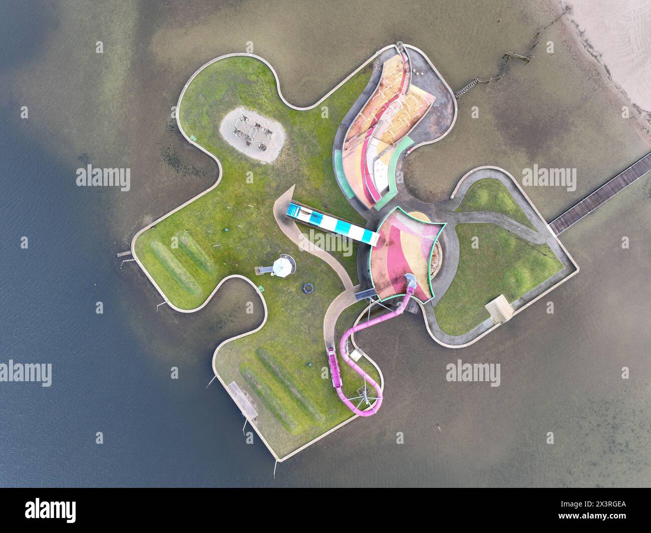 Aerial drone view children playground in the form of a puzzle piece. Colorfull recreation area with slide, swing and climbing racks at Maarsseveens Stock Photo