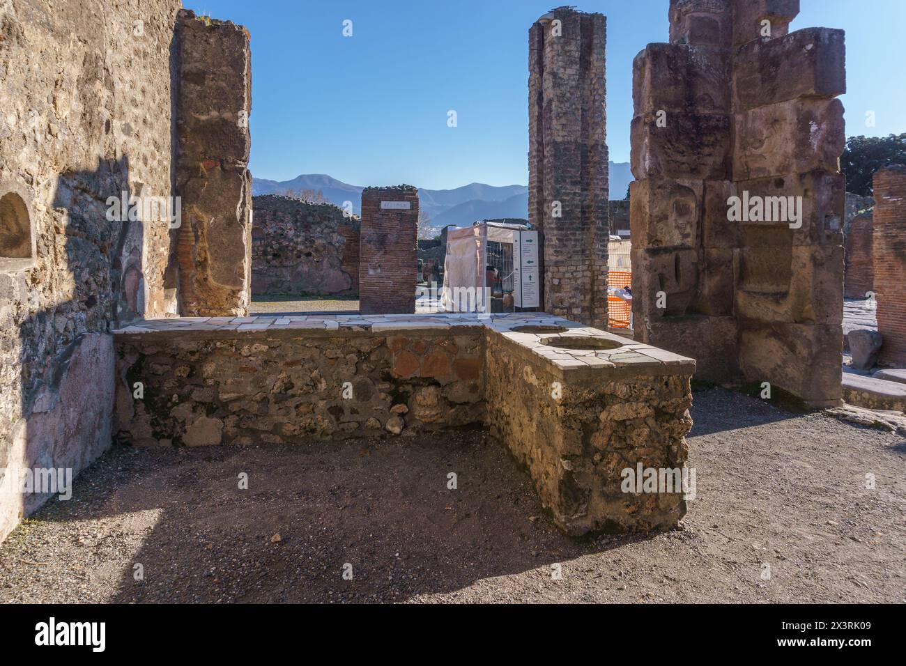 Ancient food counter with ceramic pots at the ancient roman city of Pompeii, Campania, Italy Stock Photo
