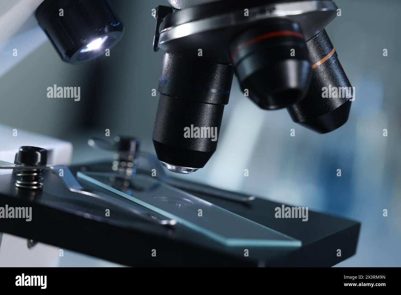 Microscope with glass slide on blurred background, closeup Stock Photo ...