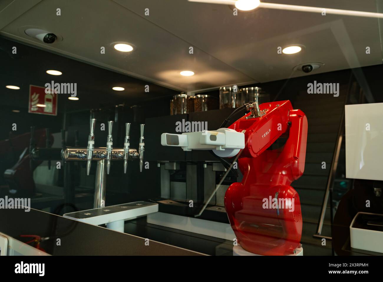 red programmable Tesla robot, robotic mechanical arm with functions to human arm in Gigafactory Berlin-Brandenburg Tesla manufacturing plant, Berlin, Stock Photo