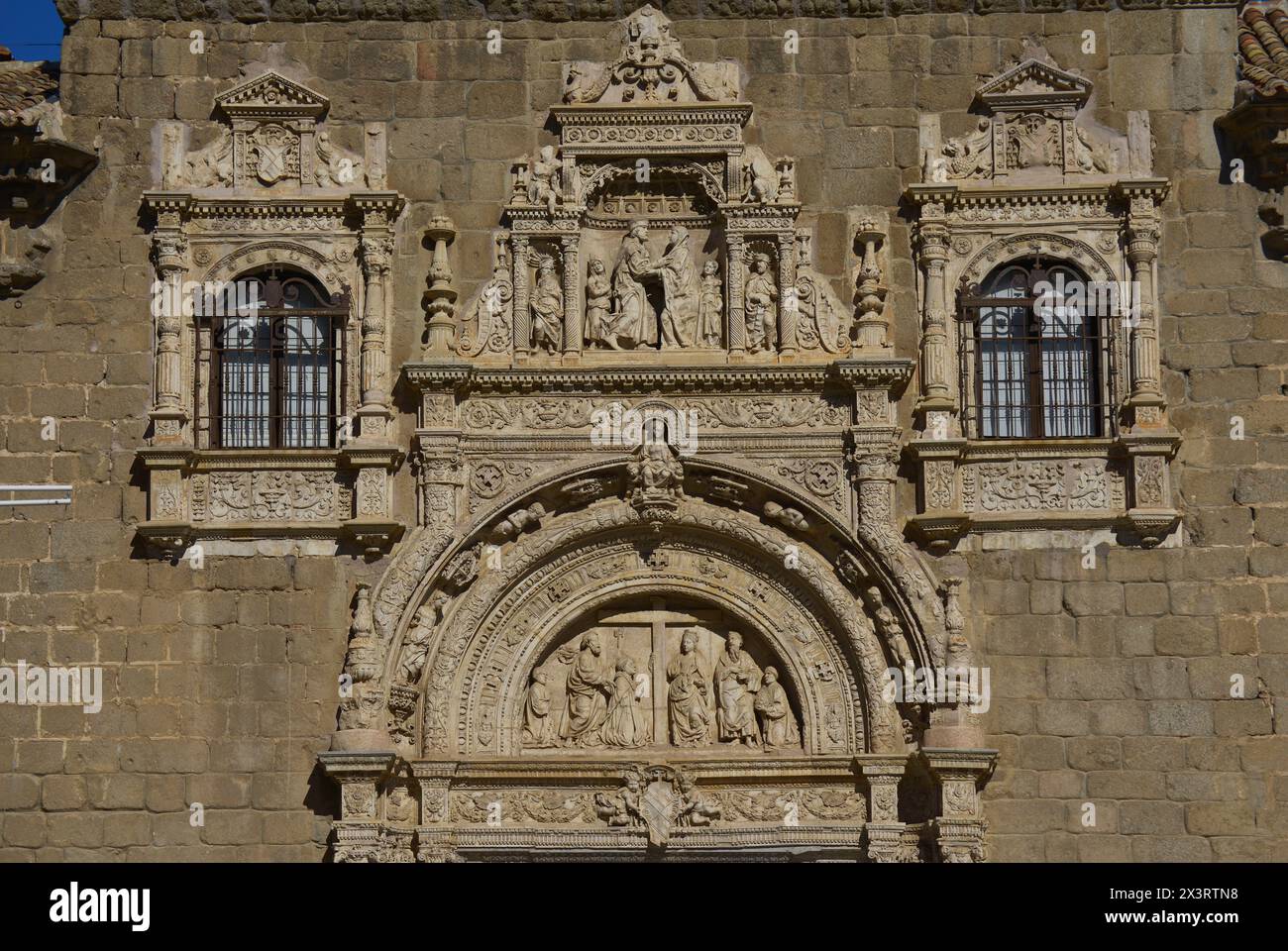 Toledo, Castile-La Mancha, Spain. Hospital de Santa Cruz. Founded by Cardinal Mendoza (1428-1495) at the end of the 15th century. View of the central part of the façade of the building, constructed in the Plateresque style in the 1520s, by Alonso de Covarrubias (1488-1570). In the tympanum, the Adoration of the Cross by St. Helena, St. Peter and St. Paul. In the central niche, above the tympanum, the embrace of St. Joachim and St. Anne at the Golden Gate of Jerusalem. The building houses the Museum of Santa Cruz. Author: Alonso de Covarrubias (1488-1570). Spanish architect. Stock Photo