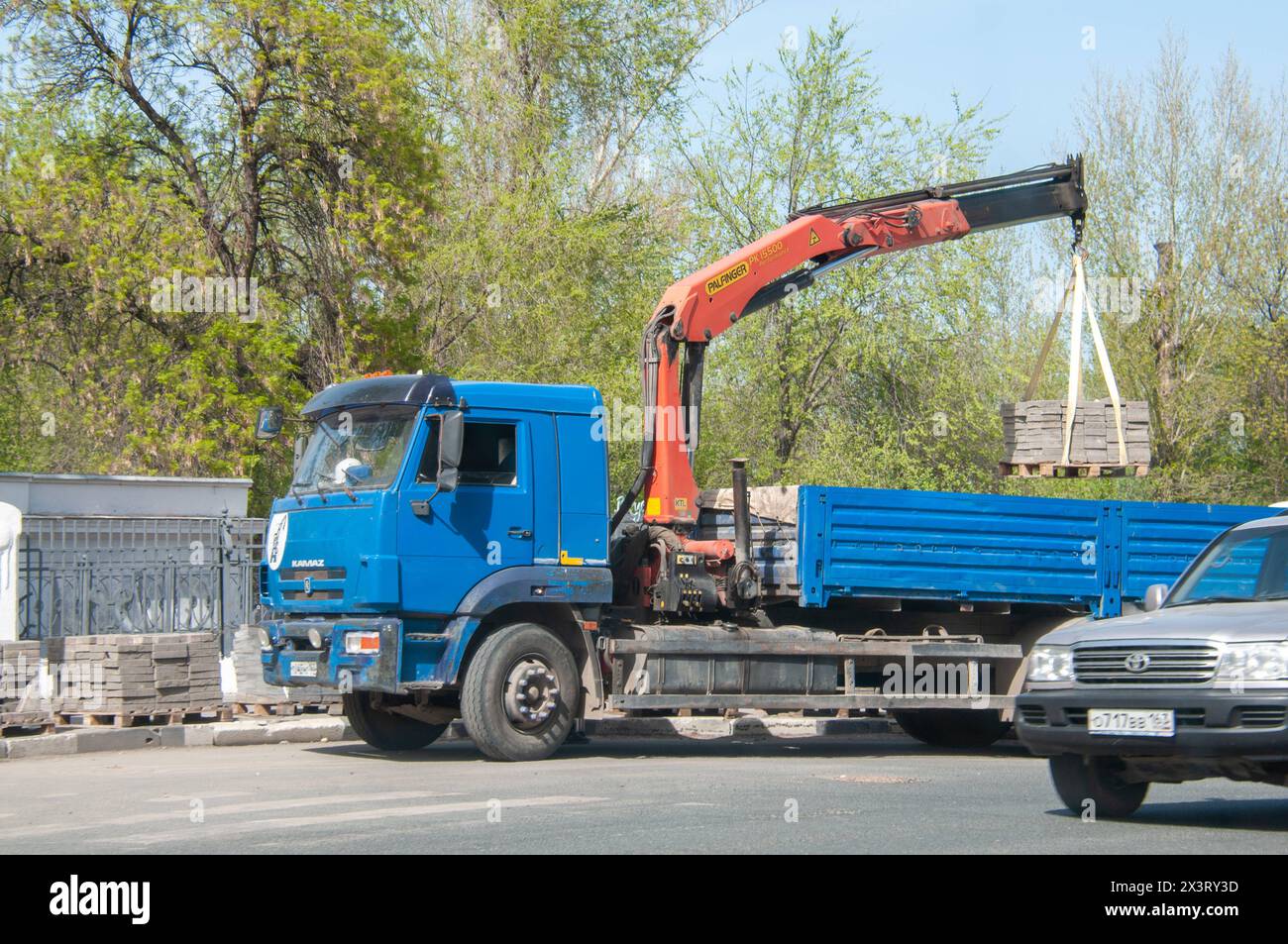 Construction works Unloading of paving slabs from the side of a truck ...