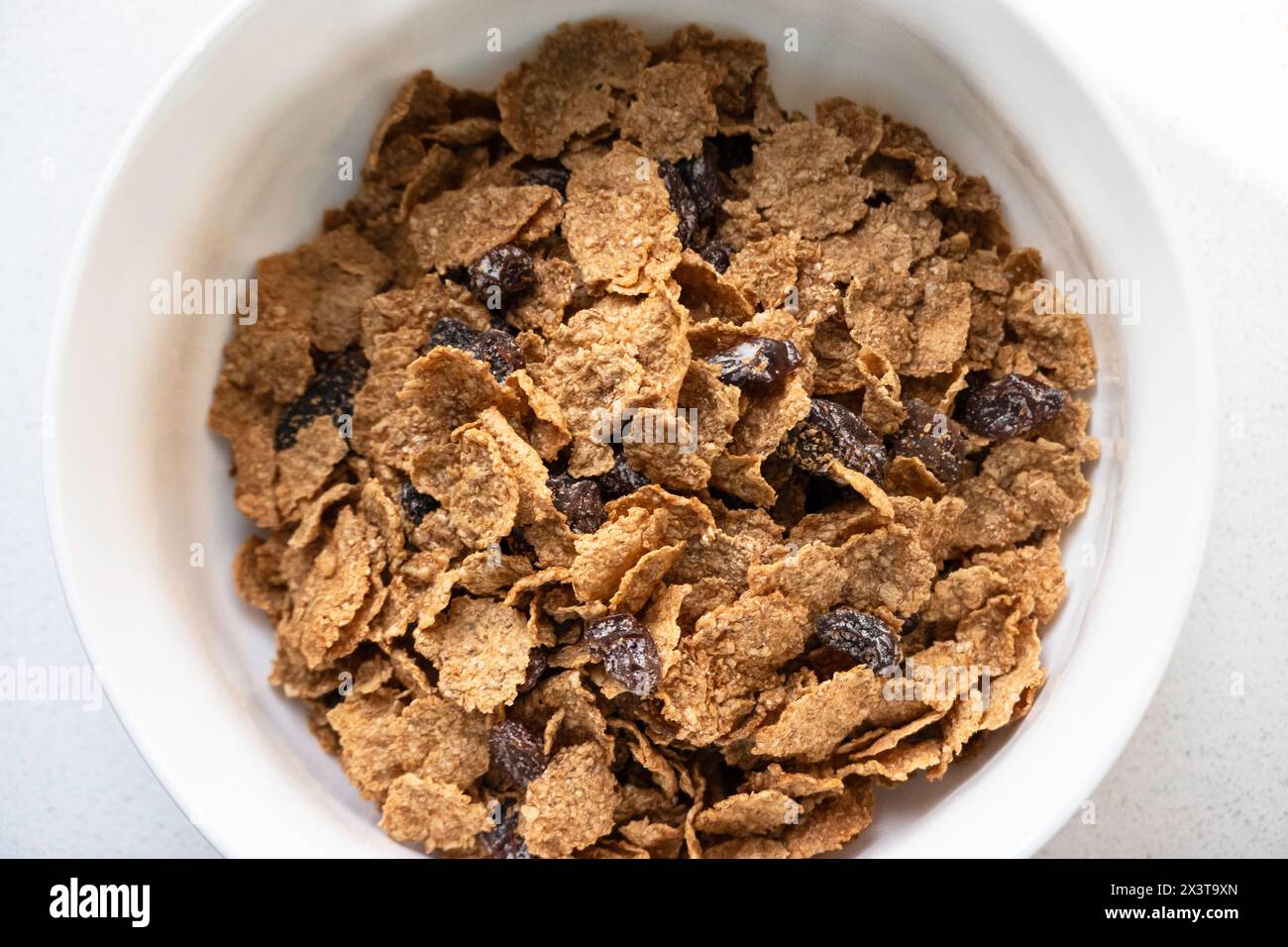 A bowl of Raisin and Bran breakfast cereal without milk. Closeup. USA. Stock Photo