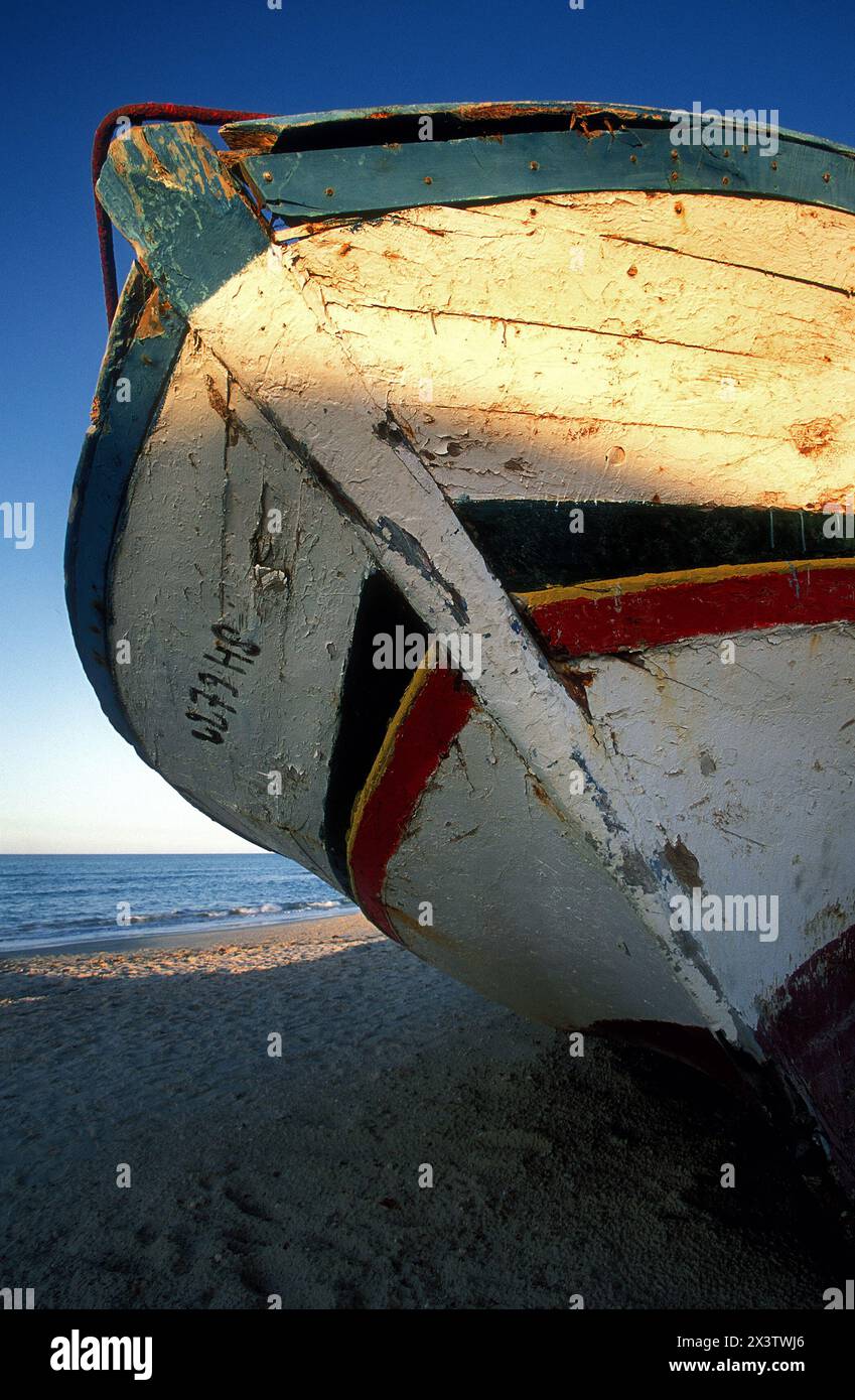 Old wooden boat on beach, Tunisia Stock Photo