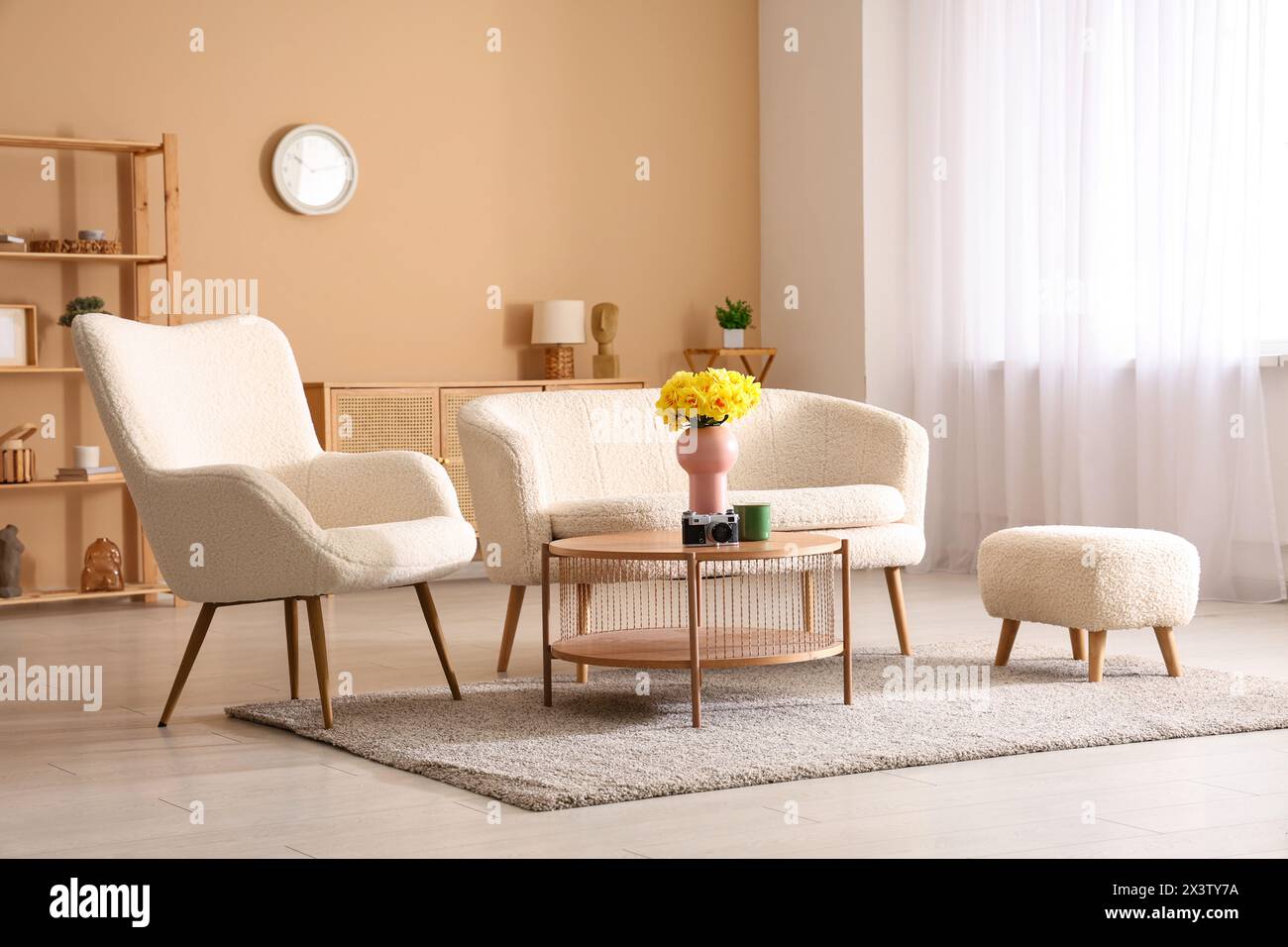 Modern interior of living room with sofa, armchair and daffodil flowers ...