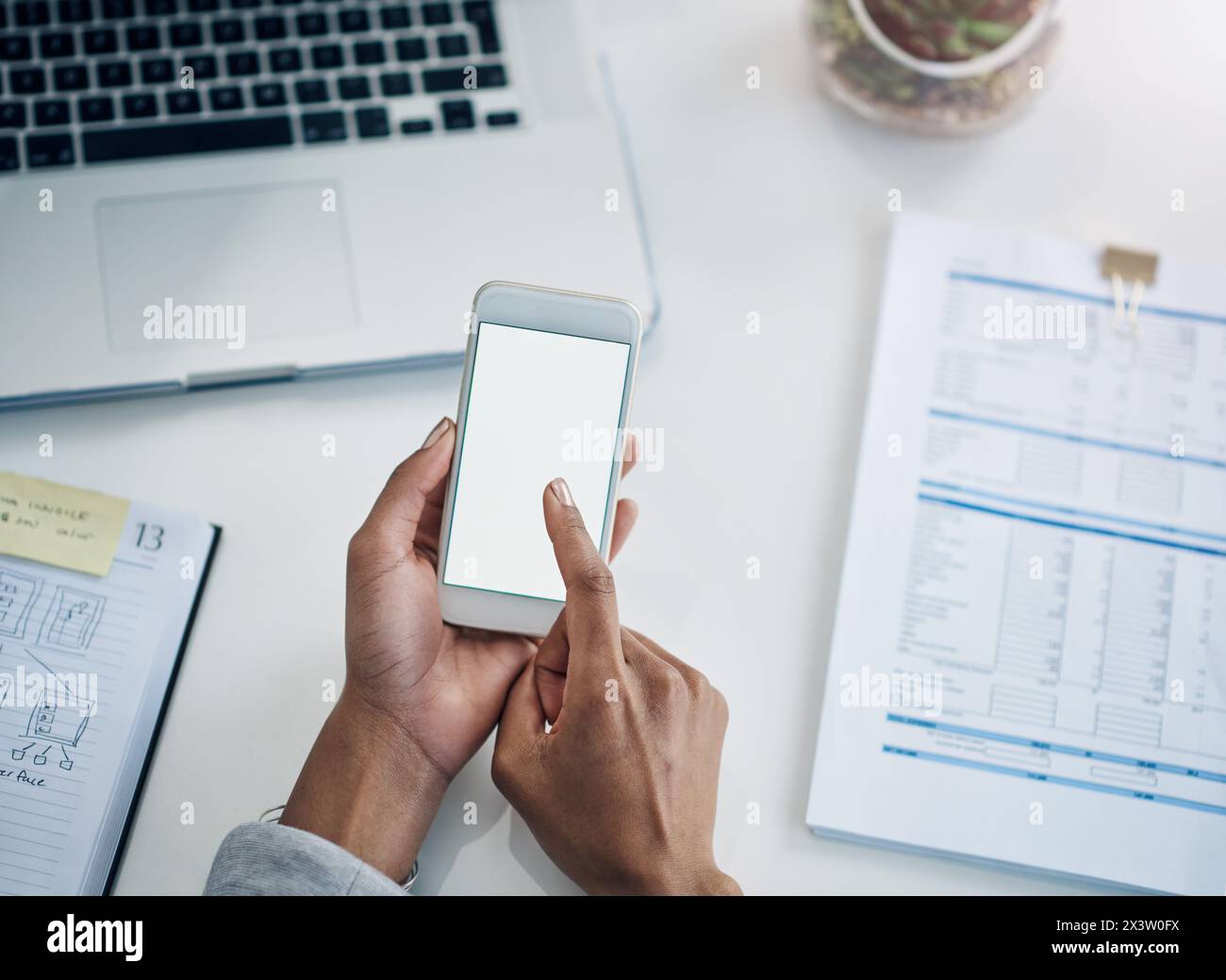 Office, scroll and hands of woman with phone screen, mockup and financial planning online. ERP, business and person at desk with mobile app Stock Photo
