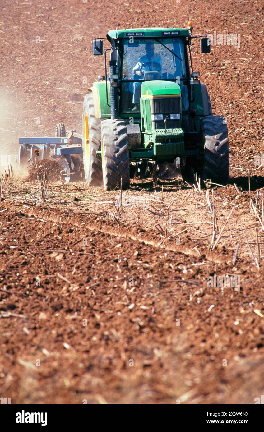 Tractor dragging a plough Stock Photo - Alamy