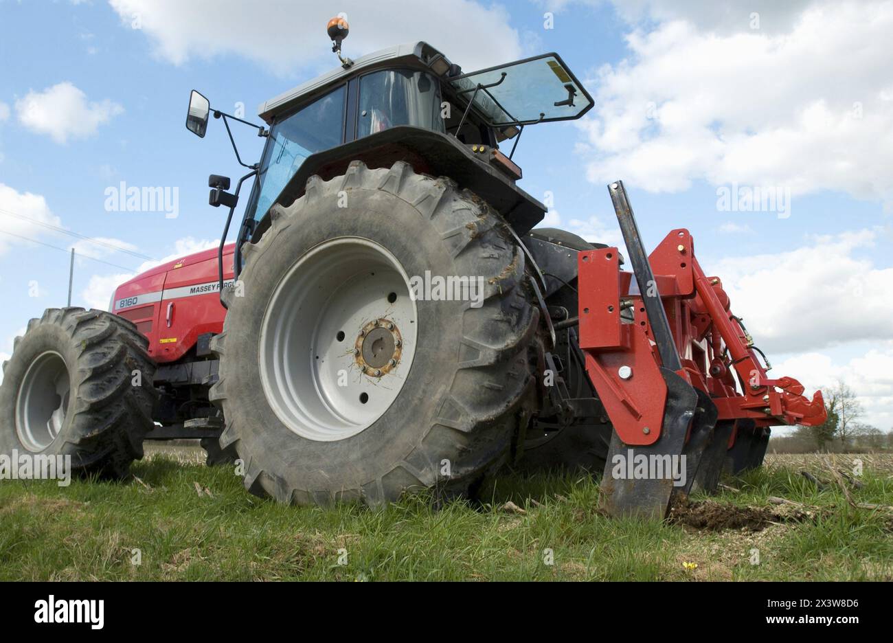 Tractor with plow at field Stock Photo - Alamy