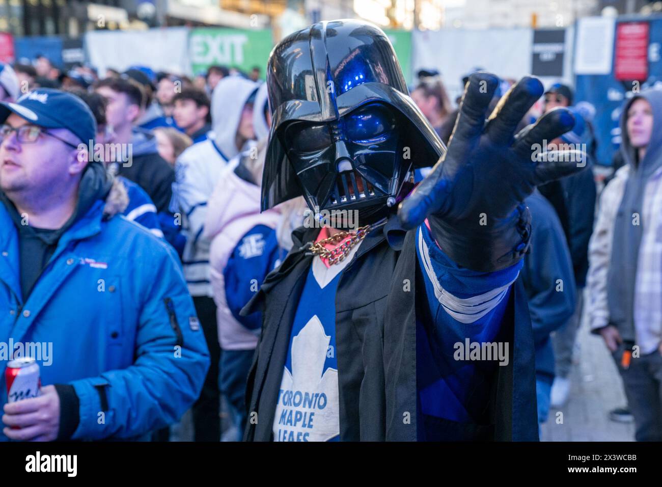 Fan dressed as Darth Vader at Maple Leaf Square outside Scotibank Arena, watching Round 1, Game 4 playoff game of Toronto Maple Leafs vs Boston Bruins playoff game on a giant screen. During Toronto Maple Leafs playoff games, Maple Leaf Square transforms into a sea of blue and white, echoing with the chants of passionate fans eagerly rallying behind their team's quest for victory. The electric atmosphere radiates anticipation and excitement, creating unforgettable memories for both die-hard supporters and casual observers alike. (Photo by Shawn Goldberg/SOPA Images/Sipa USA) Stock Photo