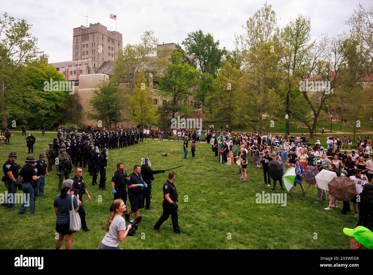 Bloomington, United States. 27th Apr, 2024. Police fill Dunn Meadow after arresting activists on the third day of a pro-Palestinian protest camp in Dunn Meadow at Indiana University. The protesters refused to take down the tents, so the Indiana State Police swat team forced them from the camp, and arrested 23. Credit: SOPA Images Limited/Alamy Live News Stock Photo