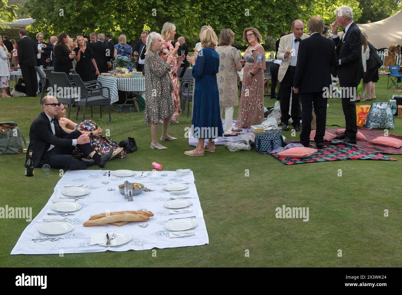 Waiting for guests to arrive 2020s UK. They are late, everyone else has started on their summer garden party alfresco picnic. The Hurlingham Club which is an exclusive private social club in the Fulham area of London. The annual summer garden party - Fête Champête, London, England 11th June 2022 UK 2020s HOMER SYKES Stock Photo