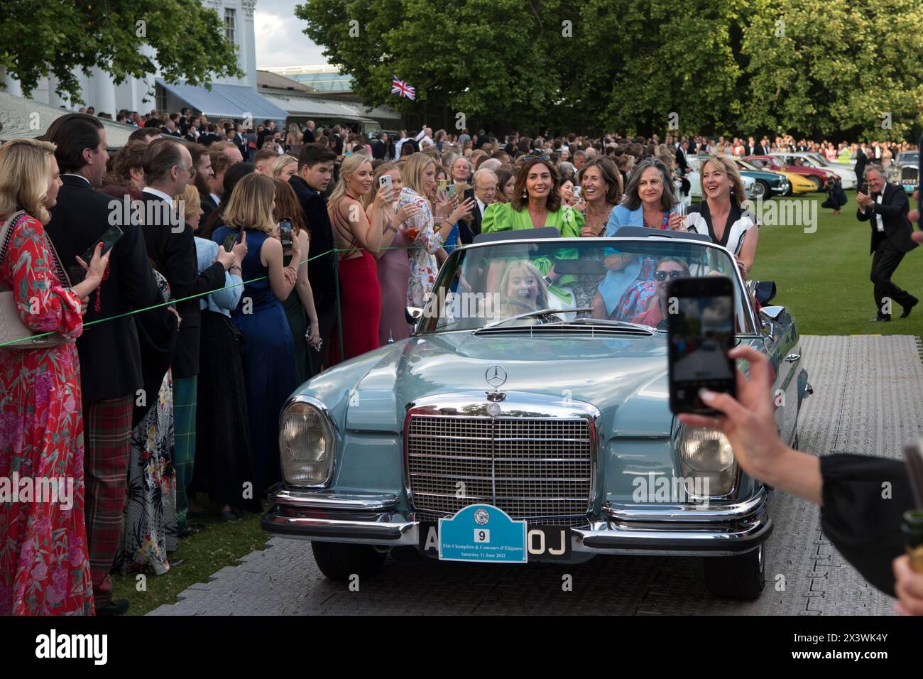 Hurlingham Club annual summer party members and their friends show off their vintage and classic cars in the Concourse d'Elégance, ie owners drive the cars around the grounds of the club. Fulham, London, England 11th June 2022 UK 2020s HOMER SYKES Stock Photo
