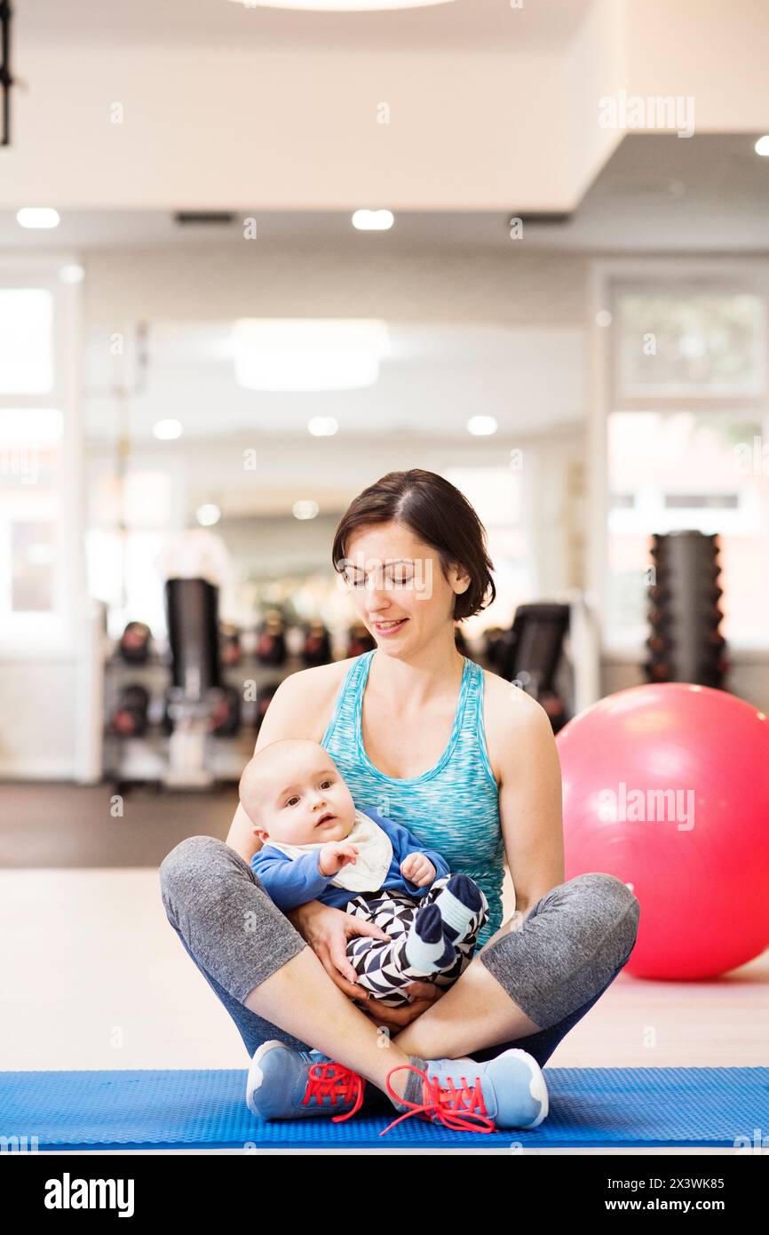 Portrait of new mom on group exercise class in gym. Moms staying active ...