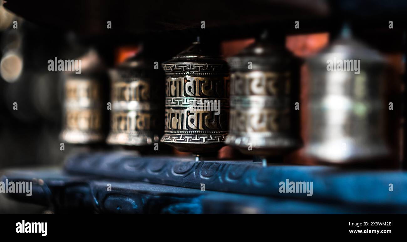 Close-up row of prayer wheels in Nepal Stock Photo